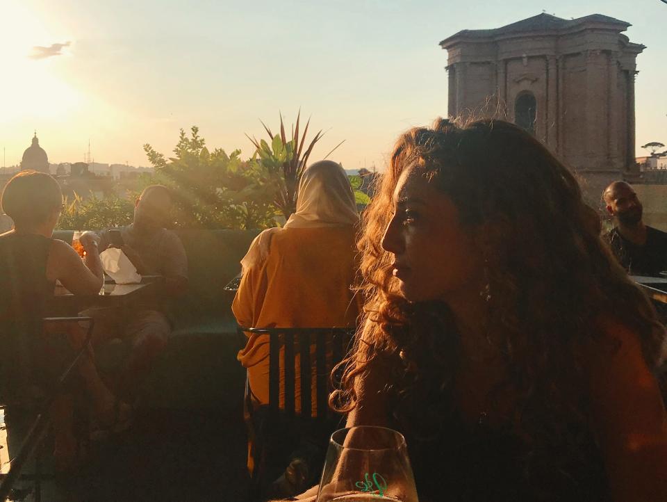 woman on a rooftop bar at sunset rome italy freelancer photo