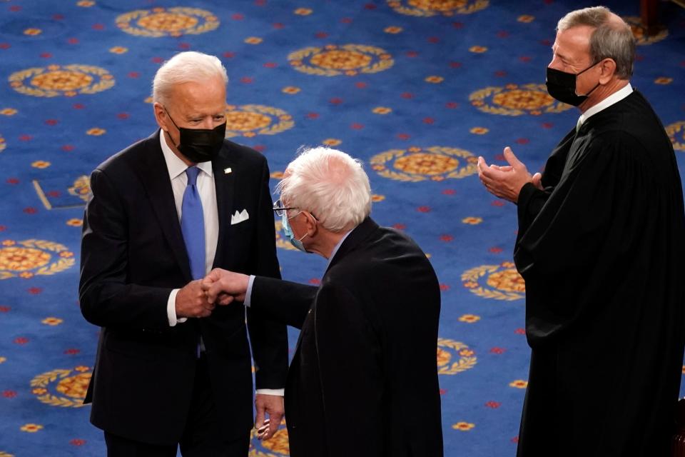 President Joe Biden greets Sen. Bernie Sanders, I-Vt., as Chief Justice of the United States John Roberts watches as Biden arrives to speak to a joint session of Congress Wednesday, April 28, 2021, in the House Chamber at the U.S. Capitol in Washington.