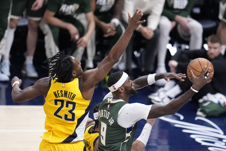 Milwaukee Bucks forward Bobby Portis (9) drives to the basket past Indiana Pacers forward Aaron Nesmith (23) during the second half in Game 6 in an NBA basketball first-round playoff series, Thursday, May 2, 2024, in Indianapolis. (AP Photo/Michael Conroy)