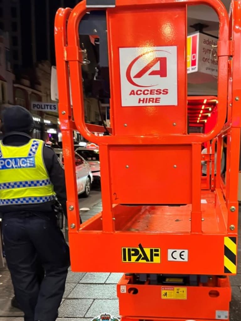 Police have arrested a man after he was caught driving a stolen scissor lift down Hindley St on Sunday morning. Picture: SAPOL