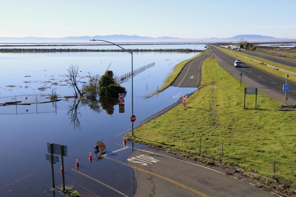 This Jan. 14, 2017 photo provided by Fraser Shilling shows flooding along Highway 37 near Vallejo, Calif. Ocean rise already is worsening the floods and high tides sweeping California this stormy winter, climate experts say, and this month's damage and deaths highlight that even a state known as a global leader in fighting climate change has yet to tackle some of the hardest work of dealing with it. (Fraser Shilling via AP)
