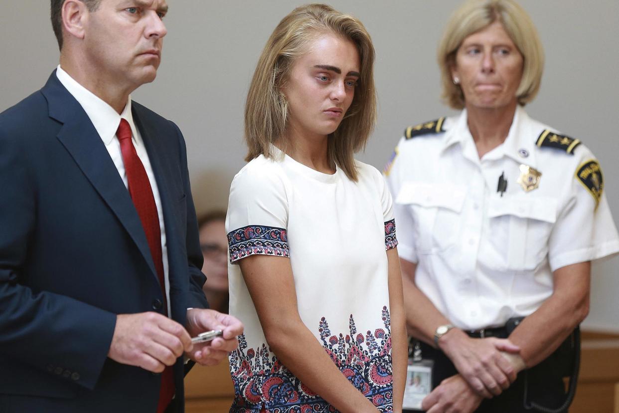 Michelle Carter, center, listens to her sentencing for involuntary manslaughter for encouraging 18-year-old Conrad Roy III to kill himself in July of 2014: Matt West/The Boston Herald via AP