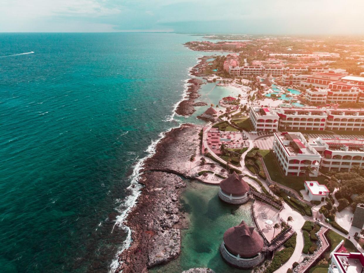 Learn more about tourism safety in Riviera Maya and how travelers can have secure trips abroad. pictured: an aerial view of the coastline of Riviera Maya and the beach side resorts