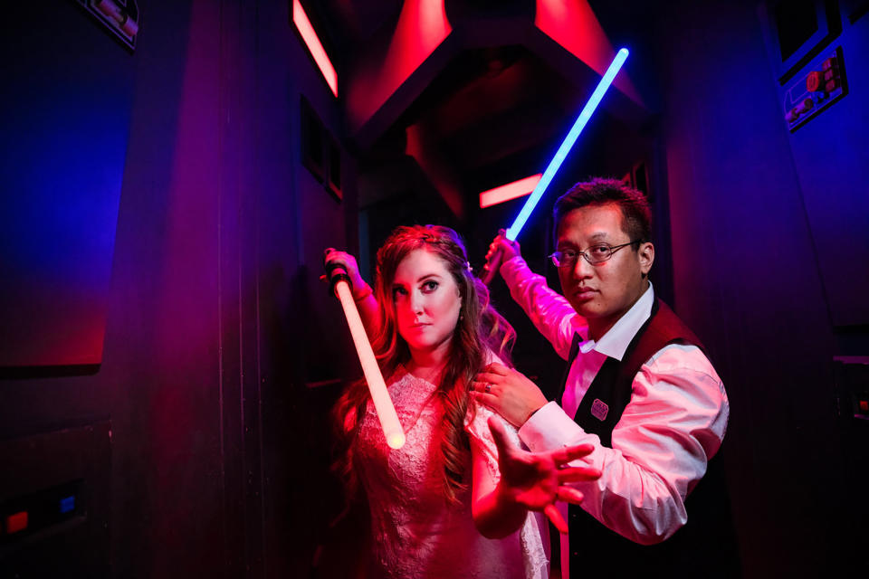 For their first vow renewal at Disneyland Resort, Shellie and her husband picked a Star Wars theme and took pictures with lightsaber props. (Photos by Jenna Henderson/White Rabbit Photo Boutique, Courtesy The Serial Bride)