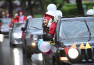 Westmont Hilltop High School graduate Chloe Whorl is shown riding in the parade in lieu of a commencement ceremony in Johnstown, Pa., Friday, May 29, 2020. (John Rucosky/Tribune-Democrat via AP)