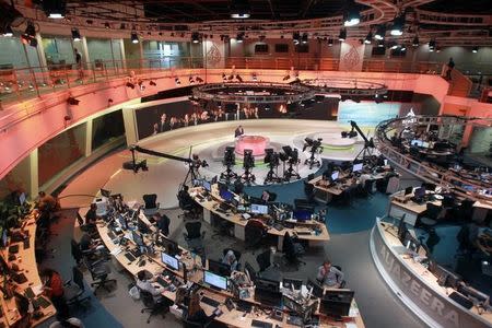 Staff work inside the headquarters of Al Jazeera Network, in Doha, Qatar June 8, 2017. REUTERS/Naseem Zeitoon