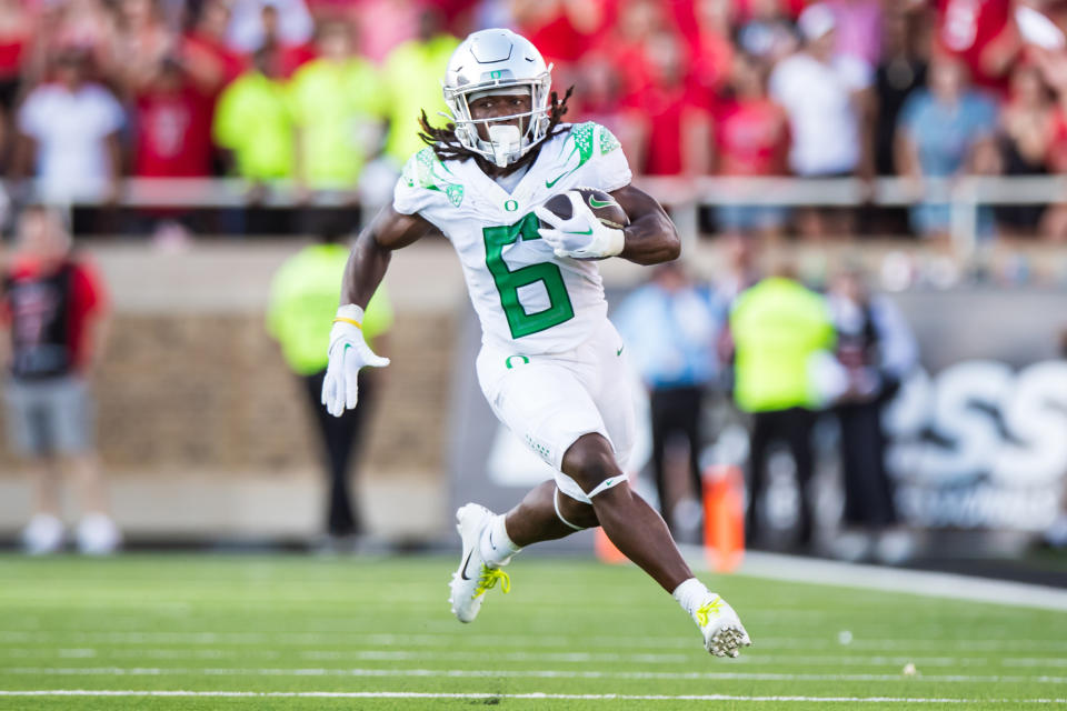 Oregon's Noah Whittington runs the ball against Texas Tech at on September 09, 2023 in Lubbock, Texas. (Photo by John E. Moore III/Getty Images)