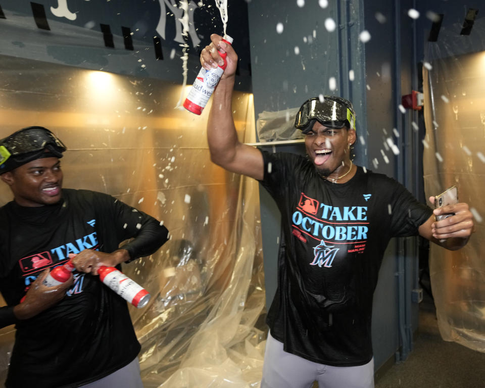 Miami Marlins' Jorge Soler, right, celebrates in the locker room after clinching a playoff berth with a 7-3 win over the Pittsburgh Pirates in a baseball game in Pittsburgh, Saturday, Sept. 30, 2023. (AP Photo/Gene J. Puskar)