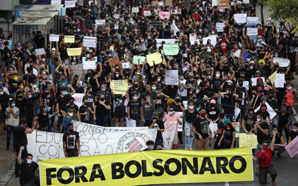 Protesters in the Brazilian state of Manaus call for President Jair Bolsonaro to leave office over his handling of the coronavirus crisis - BRUNO KELLY/REUTERS