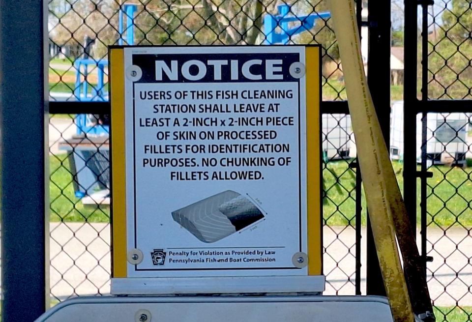 A sign at the North East Marina public fish cleaning station near Erie advises anglers to leave at least a two-inch square of skin on their fish filets.
