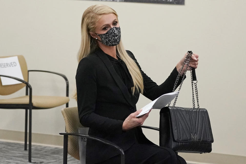 Paris Hilton looks on before speaking at a committee hearing at the Utah State Capitol, Monday, Feb. 8, 2021, in Salt Lake City. Hilton has been speaking out about abuse she says she suffered at a boarding school in Utah in the 1990s and she testified in front of state lawmakers weighing new regulations for the industry. (AP Photo/Rick Bowmer)