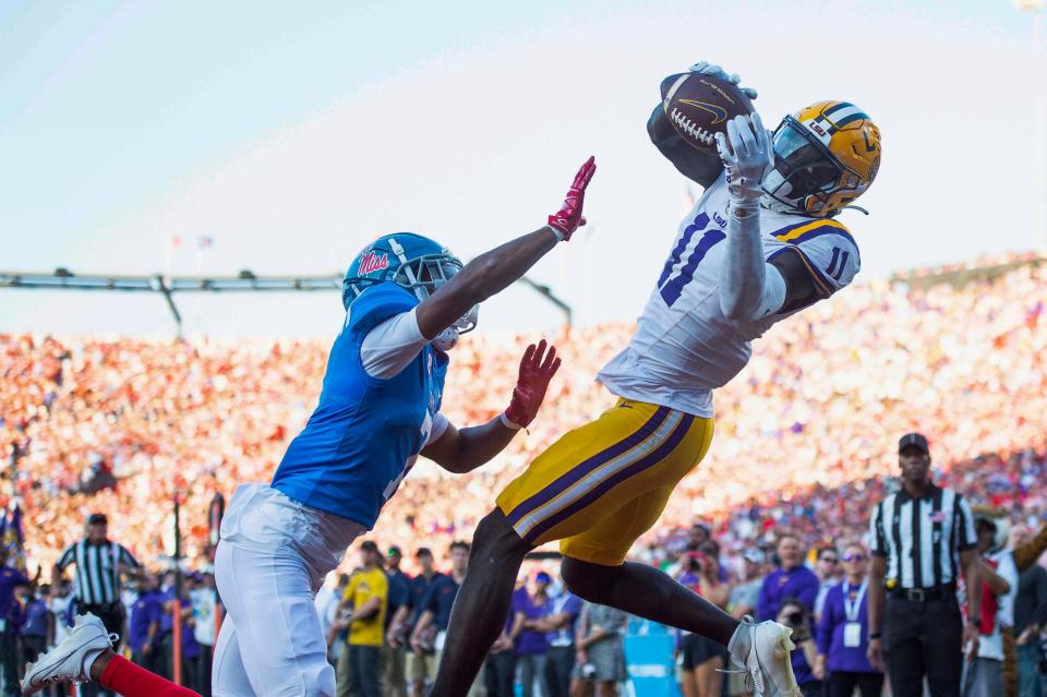 OXFORD, MISSISSIPPI - SEPTEMBER 30: Wide receiver Brian Thomas Jr. #11 of the LSU Tigers catches a pass for a touchdown in front of cornerback Deantre Prince #7 of the Mississippi Rebels during the first half of play at Vaught-Hemingway Stadium on September 30, 2023 in Oxford, Mississippi. (Photo by Michael Chang/Getty Images)