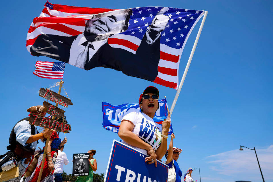 Supporters of former US President Donald Trump during a caravan outside the Mar-a-Lago Club in Palm Beach, Florida, US, on Sunday, June 11, 2023. The federal charges against Trump will test his supporters' tolerance for the growing scandals weighing on his White House comeback bid, as Republican rivals look to wrest the 2024 nomination from the former president. Photographer: Eva Marie Uzcategui/Bloomberg