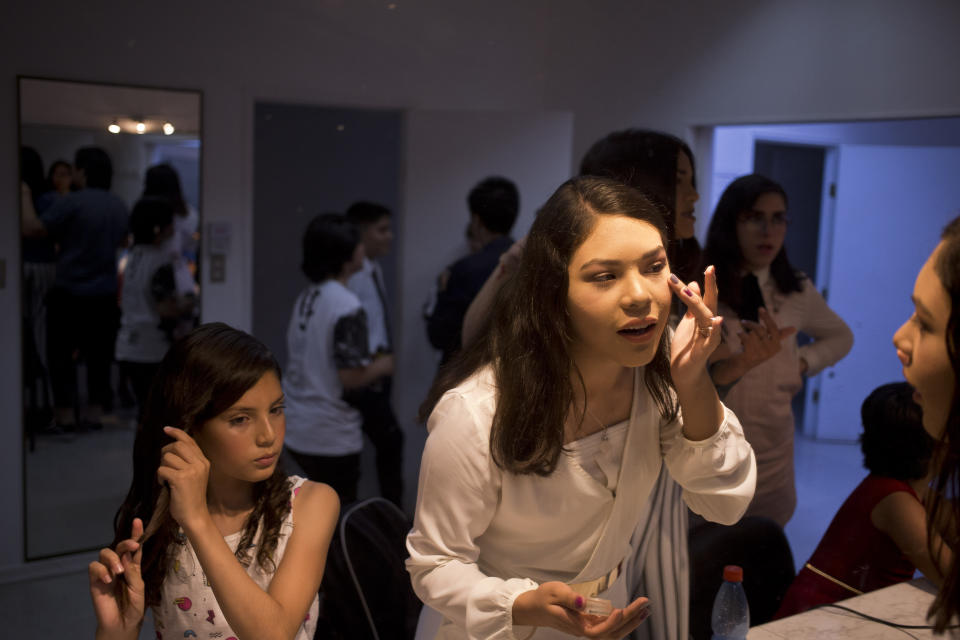 In this Dec.18, 2018 photo, transgender children prepare to attend the graduation ceremony at the Amaranta Gomez school in Santiago, Chile. Since its start, school attendance has grown from the original five students to 22 in December, and six more have already enrolled for this year. (AP Photo/Esteban Felix)