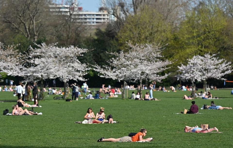 File photo: Londoners enjoy the sunshine in Battersea Park as the weather is set to get warmer (AFP via Getty Images)