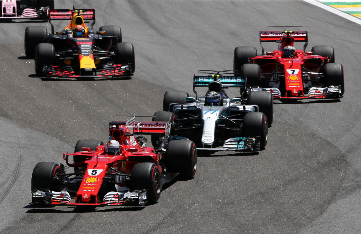 Formula One F1 – Brazilian Grand Prix 2017 – Sao Paulo, Brazil – November 12, 2017 Ferrari’s Sebastian Vettel leads Mercedes’ Valtteri Bottas at the start of the race REUTERS/Paulo Whitaker