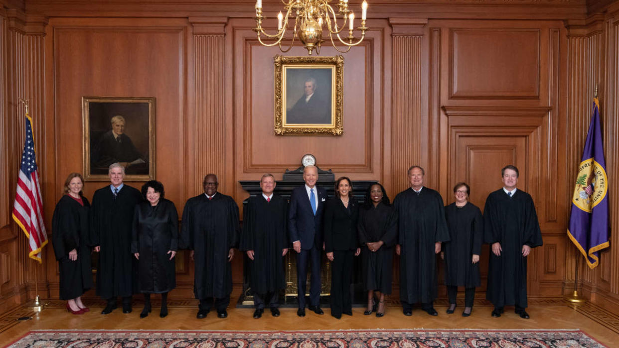 In this photo released by the US Supreme Court, (L-R) US Supreme Court justices Amy Coney Barrett, Neil Gorsuch, Sonia Sotomayor, Clarence Thomas, Chief Justice John  Roberts, US President Joe Biden, Vice President Kamala Harris, justices Ketanji Brown Jackson, Samuel Alito,  Elena Kagan, and Brett Kavanaugh pose during Jackson's investiture ceremony at the Supreme Court in Washington, DC, on September 30, 2022. (Photo by Handout / US Supreme Court / AFP) / RESTRICTED TO EDITORIAL USE - MANDATORY CREDIT 