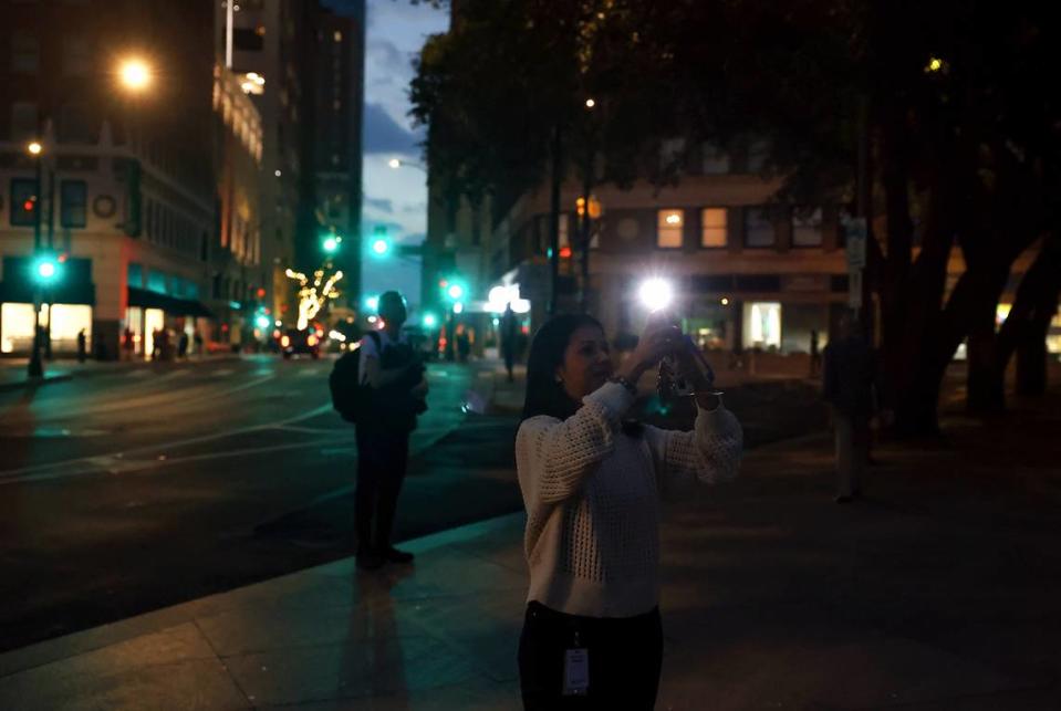 People watch the full solar eclipse near Burnett Park in downtown Fort Worth on Monday, April 8, 2024. Amanda McCoy/amccoy@star-telegram.com