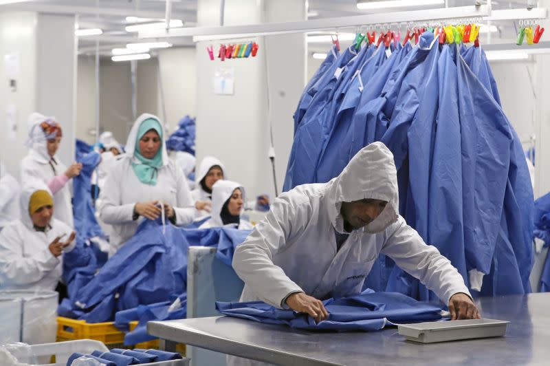 Workers are seen in a factory that produces sterilised surgical equipment and medical clothings in Egypt