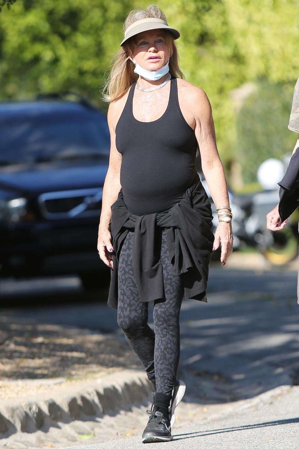 <p>Goldie Hawn dresses in a tank top and leggings to go on her daily walk with girlfriends in L.A. on Friday.</p>