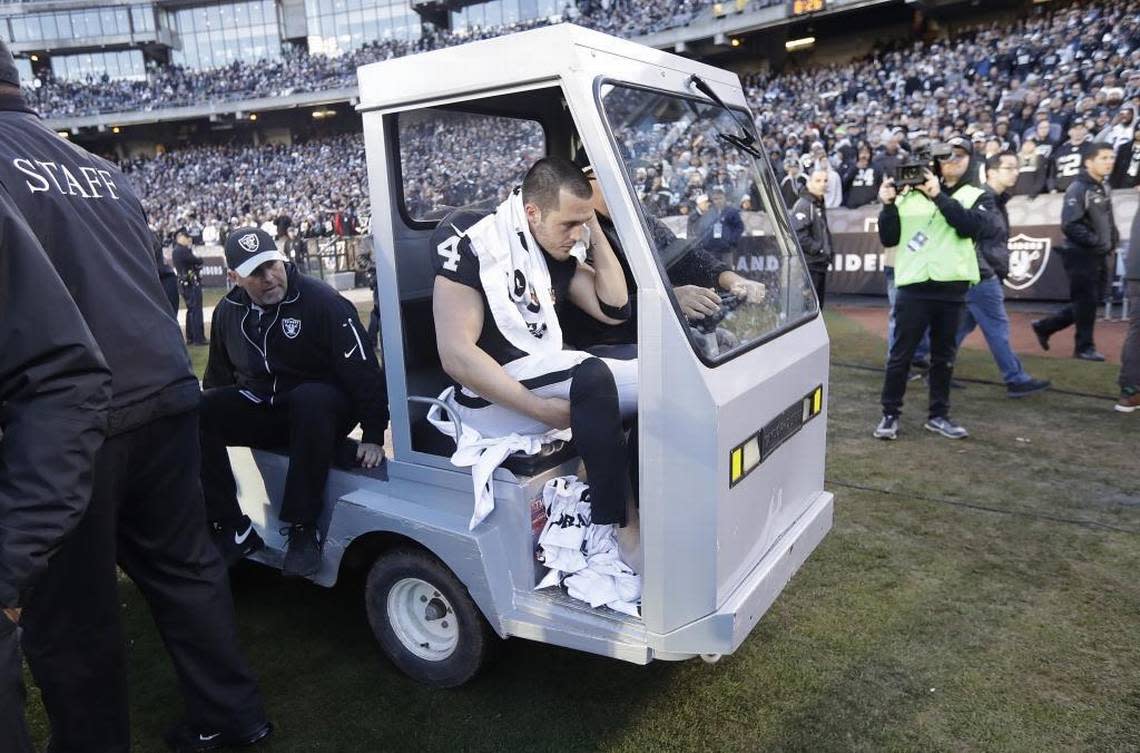 Derek Carr gets carted off the field after breaking his ankle during the second half of a Dec. 24, 2016, game against the Colts at the Coliseum.