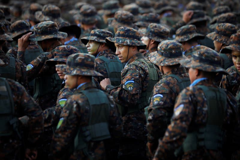 Salvadoran soldiers gather before a ceremony to deploy military personnel to support a security plan in San Salvador