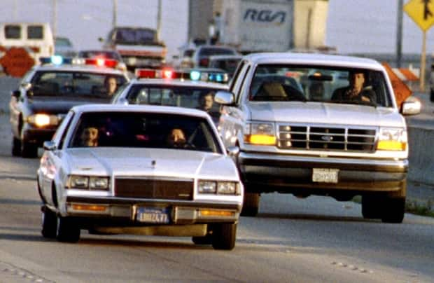 A Ford Bronco, right, is shown on June 17, 1994 driven by Al Cowlings, a friend of O.J. Simpson. The former football player was hidden in the back seat, with a lengthy slow-pursuit ending at his Los Angeles residence. 