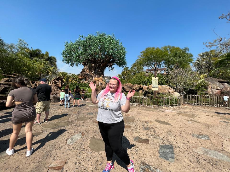 casey posing in front of animal kingdom tree of life at disney world