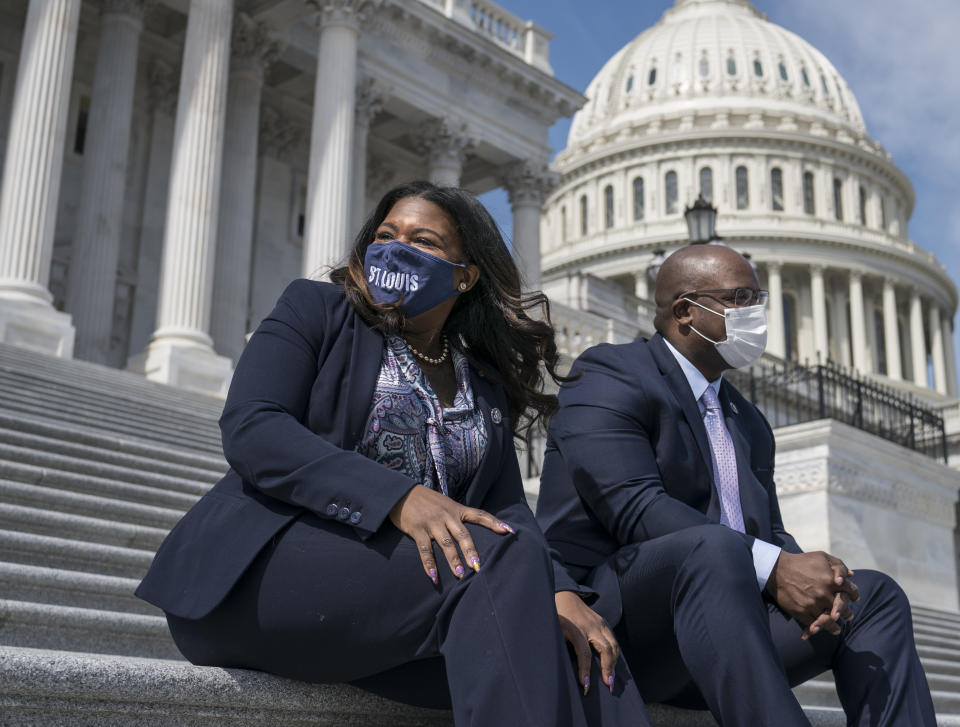 Rep. Cori Bush, D-Mo., left, and Rep. Jamaal Bowman, D-N.Y., enjoy the warm weather before a vote in the House, at the Capitol in Washington, Thursday, March 11, 2021. (AP Photo/J. Scott Applewhite)