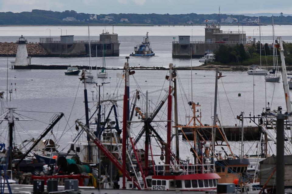 A tugboat makes its way out through the gates of the hurricane barrier protecting New Bedford Harbor.