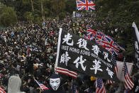 FILE - In this Sunday, Jan. 19, 2020 file photo, participants wave British and U.S. flags during a rally demanding electoral democracy and call for boycott of the Chinese Communist Party and all businesses seen to support it in Hong Kong. Only five years ago, former British Prime Minister David Cameron was celebrating a “golden era” in U.K.-China relations, bonding with President Xi Jinping over a pint of beer at the pub and signing off trade deals worth billions. Those friendly scenes now seem like a distant memory, with hostile rhetoric ratcheting up this week over Beijing’s new national security law on Hong Kong. China has threatened “consequences” after Britain offered refuge to millions in the former colony. (AP Photo/Ng Han Guan, file)