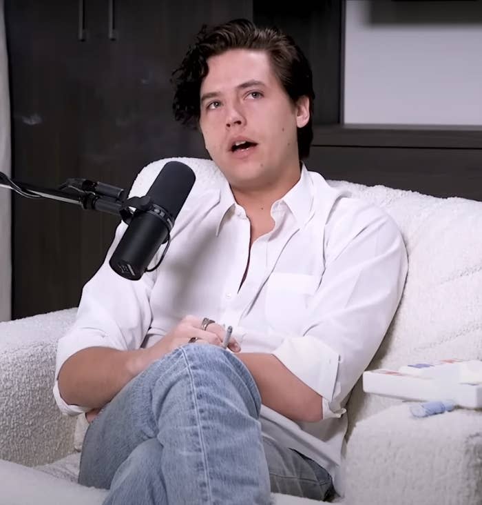 Cole sitting during the interview holding a cigarette