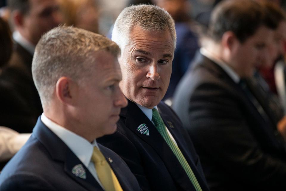 Easter Michigan head football coach Chris Creighton, right, talks to Eastern Michigan athletic director Scott Wetherbee during the MAC football media day at Ford Field on Tuesday, July 20, 2021.