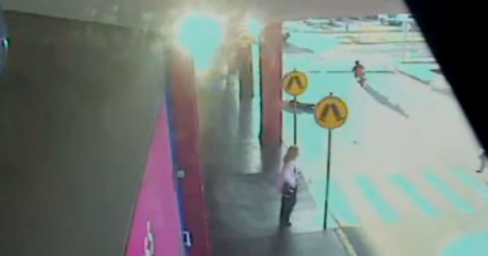 Another bike, pictured right of screen, avoided the woman on the ground and fled. Photo: CCTV