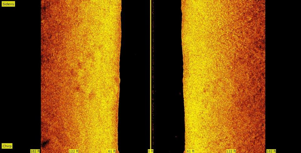 A side-scan sonar image of the Straits of Mackinac lake bottom, taken on Sept. 23, 2020, shows what appears to be stones in at least a half-circle, visible in the orange and yellow band on the left, about halfway down.  Side-scan sonar uses ultra-sonic waves bounced along a lake bottom to detect items on the sea floor. The group behind the Straits exploration believe this is evidence of rocks intentionally placed there by a culture at a time when the area would have been above-water -- around the end of the Ice Age some 10,000 years ago.