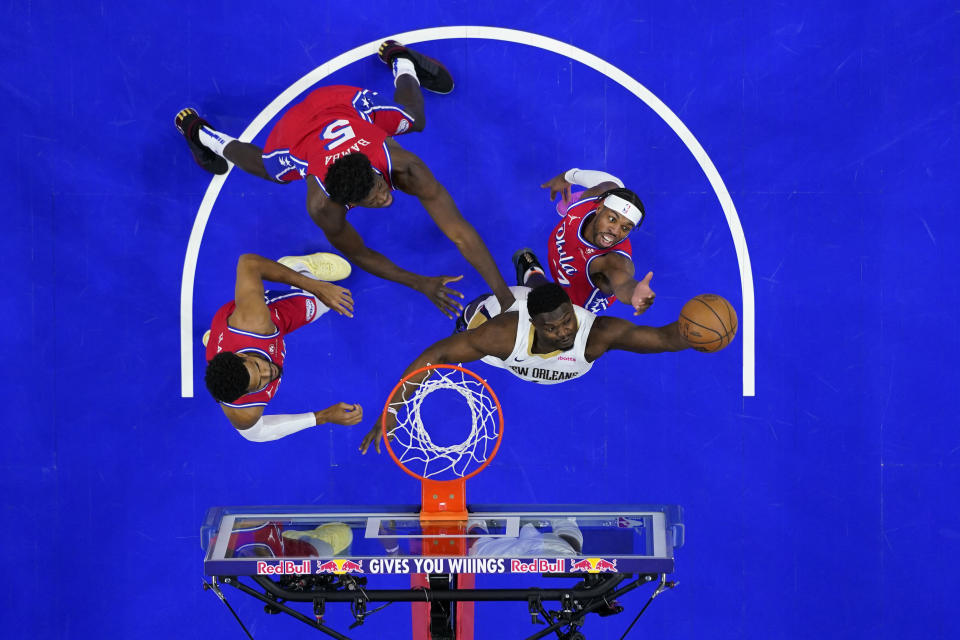 New Orleans Pelicans' Zion Williamson, from right, pulls in a rebound against Philadelphia 76ers' Buddy Hield, Mo Bamba and Tobias Harris during the first half of an NBA basketball game, Friday, March 8, 2024, in Philadelphia. (AP Photo/Matt Slocum)