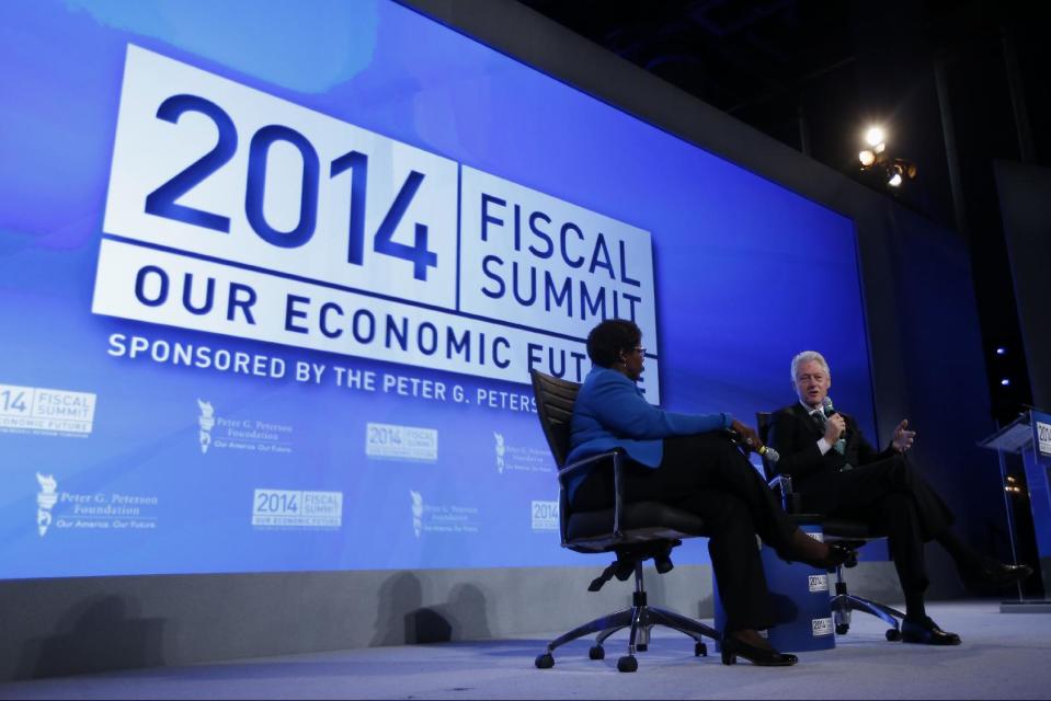 Former President Bill Clinton answers questions from Gwen Ifill of PBS NewsHour at the 2014 Fiscal Summit organized by the Peter G. Peterson Foundation in Washington, Wednesday, May 14, 2014. Lawmakers and policy experts discussed America's long term debt and economic future. (AP Photo)