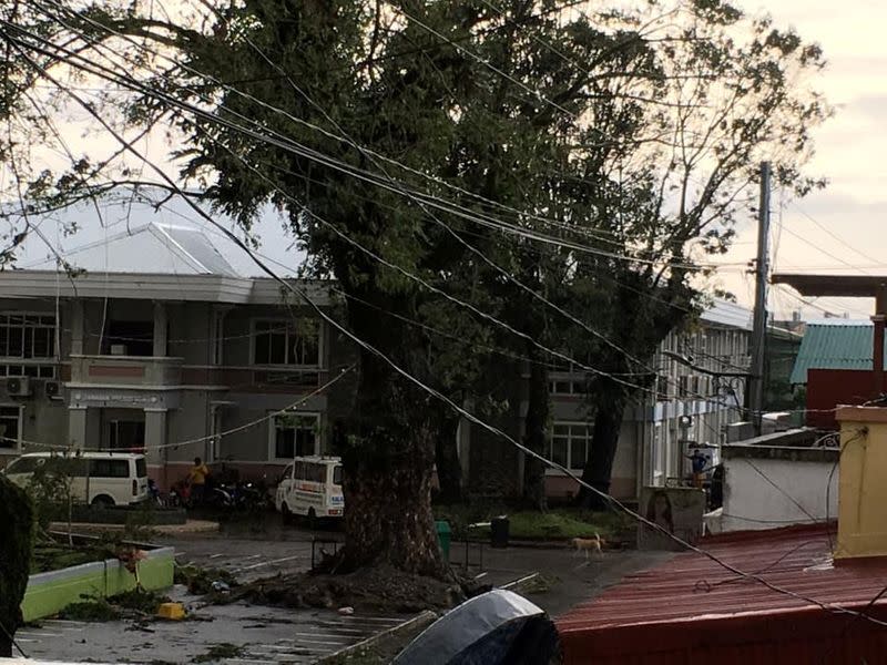 Fallen power lines dangle over buildings after Typhoon Phanfone swept through Tanauan, Leyte, in the Philippines