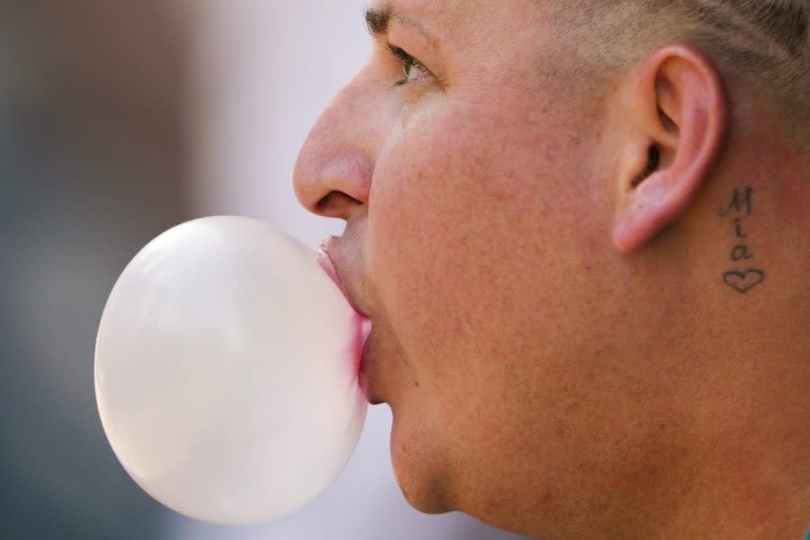 Seattle Mariners starting pitcher Jhonathan Díaz blows a bubble during the first inning of a spring training baseball game against the Cleveland Guardians, Feb. 25, 2024, in Peoria, Ariz. Gum maker Mars says its research shows half of gum consumers chew to relieve stress or help their focus. (AP Photo/Lindsey Wasson, File)