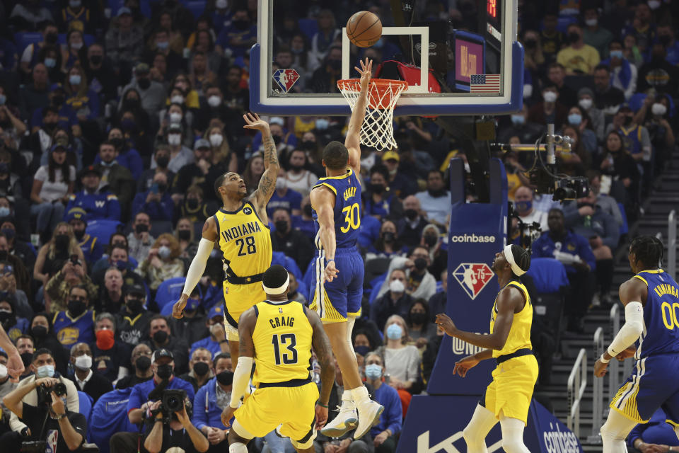 Golden State Warriors guard Stephen Curry (30) shoots against Indiana Pacers guard Keifer Sykes (28) during the first half of an NBA basketball game in San Francisco, Thursday, Jan. 20, 2022. (AP Photo/Jed Jacobsohn)