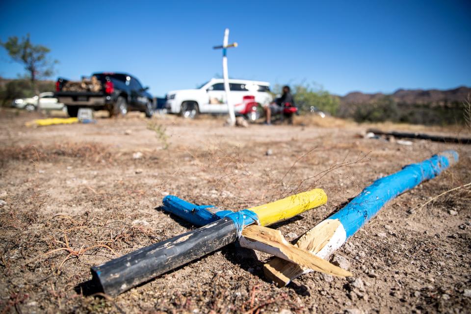 Crosses at a traditional Apache altar lay on the ground the morning after it was discovered to be vandalized at Oak Flat, a campground that is part of the Tonto National Forest in Miami, Arizona, on Oct. 29, 2021. The site, which is sacred to Apache and other Native peoples, is at risk of destruction by a land swap with the federal government to a copper mining company.