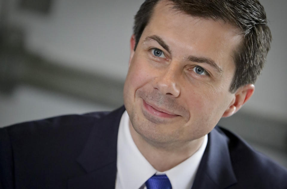 FILE - In this April 29, 2019 file photo, then Democratic presidential candidate Mayor Pete Buttigieg, from South Bend, Indiana, listens during a lunch meeting with civil rights leader Rev. Al Sharpton at Sylvia's Restaurant in Harlem neighborhood of New York. President-elect Joe Biden is expected to pick former South Bend, Indiana, mayor Pete Buttigieg to head the transportation department. (AP Photo/Bebeto Matthews, Pool)