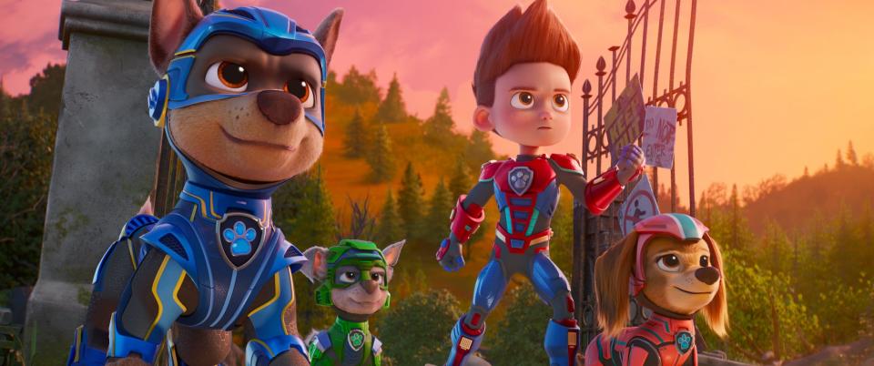 Chase (voiced by Christian Convery, far left), Rocky (Callum Shoniker), Ryder (Finn Lee-Epp) and Liberty (Marsai Martin) take on a villainous duo in "Paw Patrol: The Mighty Movie."