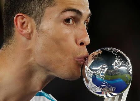 Soccer Football - FIFA Club World Cup Final - Real Madrid vs Gremio FBPA - Zayed Sports City Stadium, Abu Dhabi, United Arab Emirates - December 16, 2017 Real Madrid’s Cristiano Ronaldo kisses his award as he celebrates after the game REUTERS/Amr Abdallah Dalsh