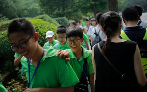Tourists visit Tsinghua University in Beijing - Credit: EPA