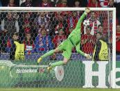 Viktoria Plzen's goalkeeper Matus Kozacik dives for the ball as Manchester City's Yaya Toure (unseen) scores a goal during their Champions League group D soccer match at the Doosan Arena in Prague, Czech Republic September 17, 2013. REUTERS/Petr Josek (CZECH REPUBLIC - Tags: SPORT SOCCER)