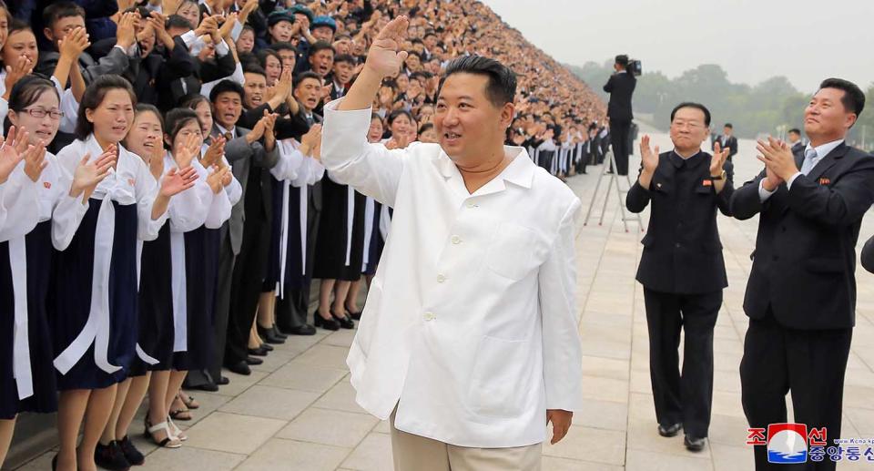 North Korean leader Kim Jong-un waves as he attends a photo session with participants during Youth Day celebrations, in Pyongyang, North Korea.