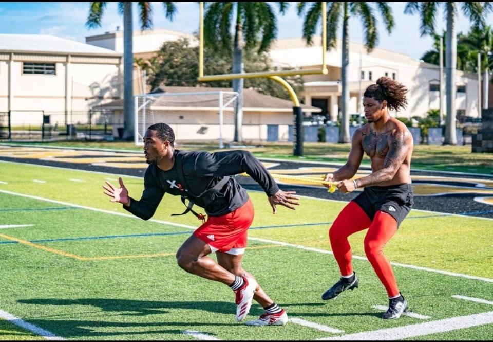 Dominique Robinson works out with Andrew Olgetree of Youngstown State in Fort Meyers, Florida.