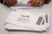 Election worker Monica Ging processes ballots for the Pennsylvania primary election at the Chester County Voter Services office, Thursday, May 19, 2022, in West Chester, Pa. (AP Photo/Matt Slocum)