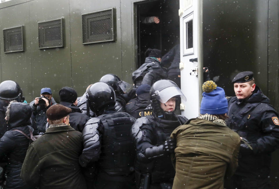 Belarus police detain protesters during an opposition rally in Minsk, Belarus, Saturday, March 25, 2017. A cordon of club-wielding police blocked the demonstrators' movement along Minsk's main avenue near the Academy of Science. Hulking police detention trucks were deployed in the city center. (AP Photo/Sergei Grits)